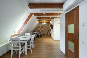 Modern loft interior of apartment. Brick wall. Wooden design. Furniture and tv. Private house.