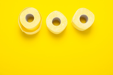 toilet paper rolls on a yellow background. Flat lay, top view. Hygiene concept, deficiency, quarantine