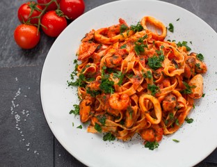 Tasty seafood pasta over a rustic background