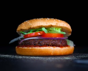 Tasty burger with tomato and lettuce