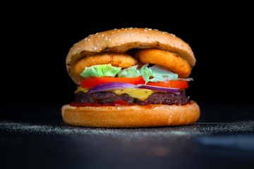 Tasty cheeseburger with onion rings