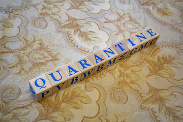 Wooden cubes with lettering Quarantine in blue letters