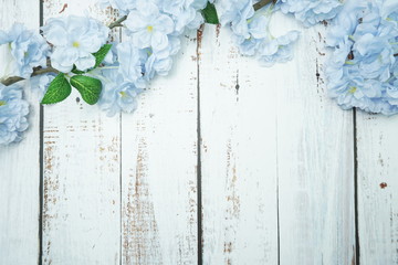 Top view Blooming Flowers frame with copy space on wooden background