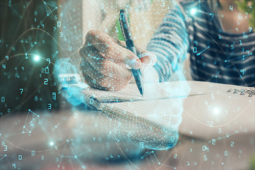 Multi exposure of writing hand on background with brain hologram. Concept of self learning.