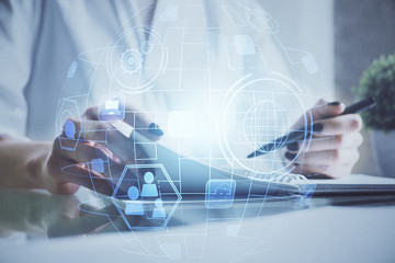 Social network theme hologram over woman's hands writing background. Concept of international people connect. Double exposure