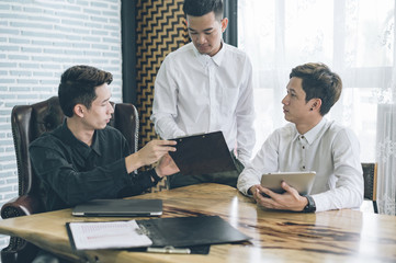 business partners discussing documents and ideas at meeting