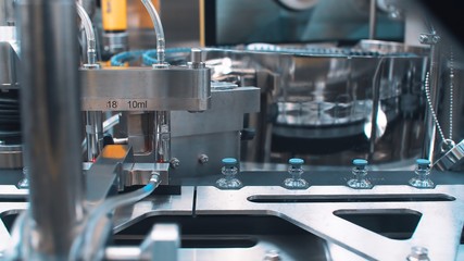 Automatic packaging machine for packaging ampoules with vaccine, injection and medical drugs.close up. coronavirus.