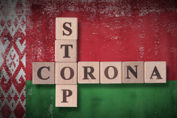 Flag of Belarus with wooden cubes spelling STOP CORONA on it. 2019 - 2020 Novel Coronavirus (2019-nCoV) concept art, for an outbreak occurs in Belarus.