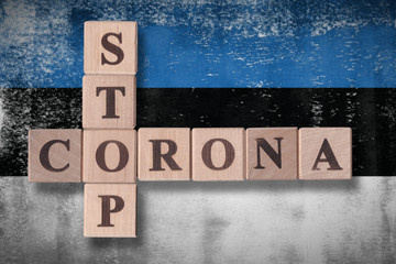 Flag of Estonia with wooden cubes spelling STOP CORONA on it. 2019 - 2020 Novel Coronavirus (2019-nCoV) concept art, for an outbreak occurs in Estonia.