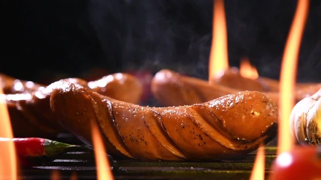 Grilled sausages on the flaming grill
