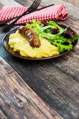 Mashed potato with cream, butter and emmental, grilled sausage