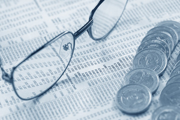 euro coins and glasses on the documents