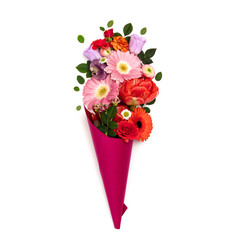 Bouquet of flowers in paper cone on a white background