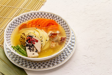 Korean noodle soup with smoked chicken and vegetables. Spring spicy dish for healthy meal