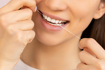dental floss with a smile and beautiful teeth. flossing