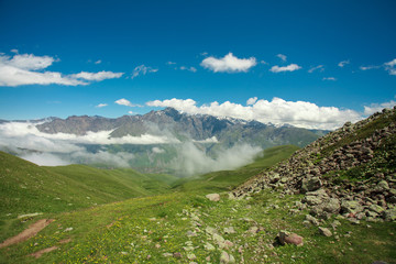 beautiful mountain landscape with fog in Georgia in summer sunny day. wide nature and locality in Georgia. clouds on  blue sky background in mountain 