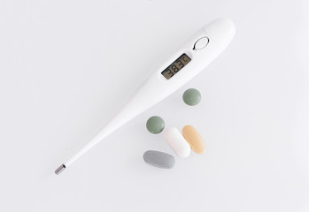  thermometer and pills isolated. treatment of the disease and high fever, hospitalization in the hospital