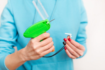 Girl Holds in hands, clothing tagging gun and for clothing identification