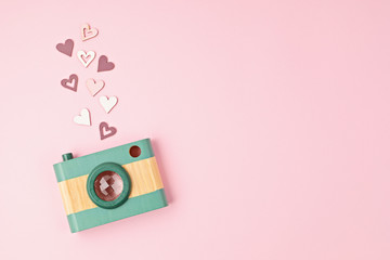 Flat lay with toy wooden camera and hearts. Social media, posts, likes, followers, online...