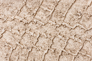 Mud tyre mark background. Wet sand tire print texture. Car trail track pattern.