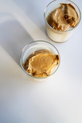 South Korean coffee dalgona – trendy cold latte or cappuccino with milk and cane sugar. Summer drink for breakfast