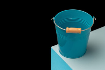 The bucket is empty, on an illusion three-dimensional cube. Conceptual ideas. On a black background.