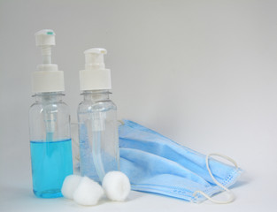 Sanitary mask, pressed alcohol bottles, cotton buds, hand washing gel on white