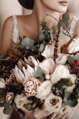 bridal bouquet with protea and pink and white roses