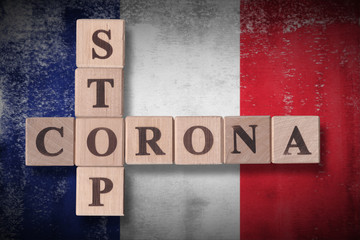 Flag of France with wooden cubes spelling STOP CORONA on it. 2019 - 2020 Novel Coronavirus (2019-nCoV) concept art, for an outbreak occurs in France.