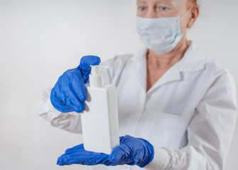 Sanitizer and liquid soap in the hands of a woman. Disinfection from viruses.