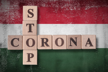 Flag of Hungary with wooden cubes spelling STOP CORONA on it. 2019 - 2020 Novel Coronavirus (2019-nCoV) concept art, for an outbreak occurs in Hungary.