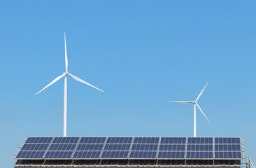 Solar panels and wind turbines generating electricity is solar energy and wind energy in hybrid power plant systems station use renewable energy to generate electricity