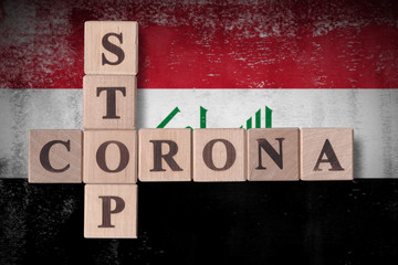 Flag of Iraq with wooden cubes spelling STOP CORONA on it. 2019 - 2020 Novel Coronavirus (2019-nCoV) concept art, for an outbreak occurs in Iraq.