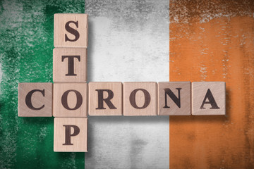Flag of Ireland with wooden cubes spelling STOP CORONA on it. 2019 - 2020 Novel Coronavirus (2019-nCoV) concept art, for an outbreak occurs in Ireland.