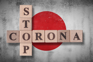 Flag of Japan with wooden cubes spelling STOP CORONA on it. 2019 - 2020 Novel Coronavirus (2019-nCoV) concept art, for an outbreak occurs in Japan.