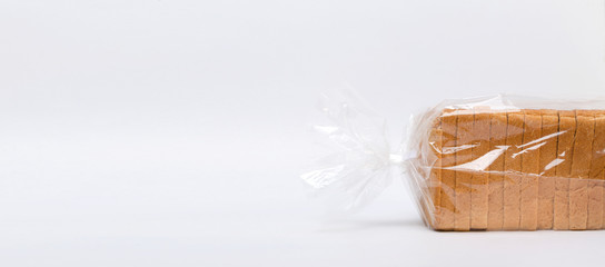 Wrapped white bread for toats on the white surface.Empty space for text