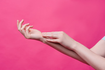 Beautiful, young female hands on a pink background. Hygiene, freshness and skin care concept, hands of a massage therapist or cosmetologist, industry of beauty salons and spas