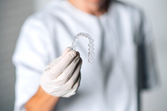 People in a dental lab working in the fabrication process of dental transparent aligners