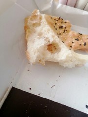 a broken piece of flatbread on a white background