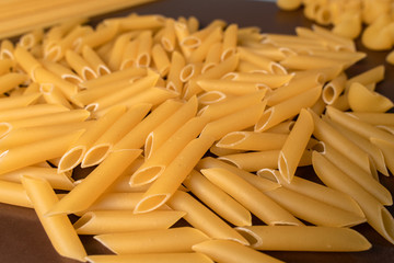 scattering Italian pasta penne, feathers
