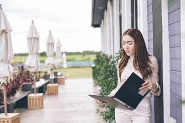 Fototapeta premium Modern business woman in the office with copy space, beautiful woman on the background of business people, Successful business woman looking confident and smiling.