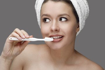 girl with a white toothbrush in a towel
