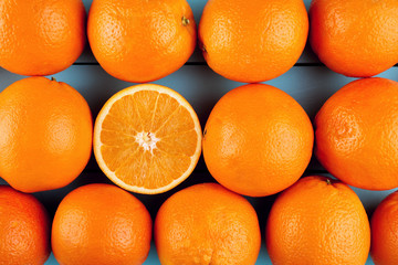 Fresh oranges in a row with one half slice