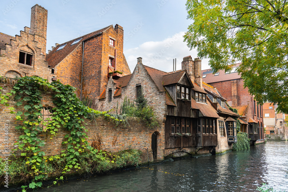 Sticker Canal between old houses of famous Flemish medieval city Brugge. Bruges, Belgium