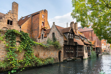 Fototapeta na wymiar Canal between old houses of famous Flemish medieval city Brugge. Bruges, Belgium