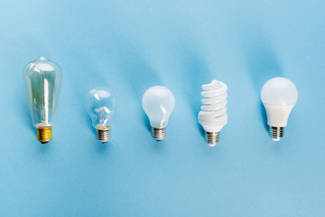 top view of light bulbs on blue, evolution concept