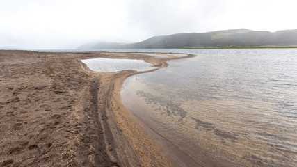Tolmachev lake in overcast weather, large freshwater lake in the east of Kamchatka Peninsula, Russia