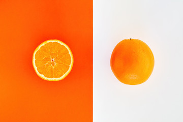 One whole and one halved slice of orange comparison