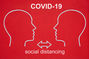 Two outlines of heads in white face each other. The text CORVID-19 and social distancing is written on the fireplace red background. Two arrows point in opposite directions.
