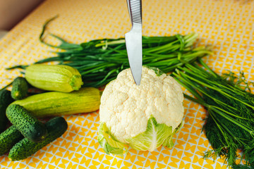 Healthy nutrition, healthy food on the table, greens and vegetables, cauliflower, cucumbers and...